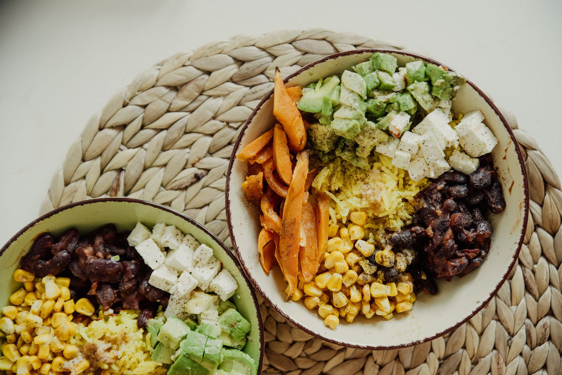 Traditional Nicoya diet three sisters: corn tortillas, black beans and roasted squash on a wooden table