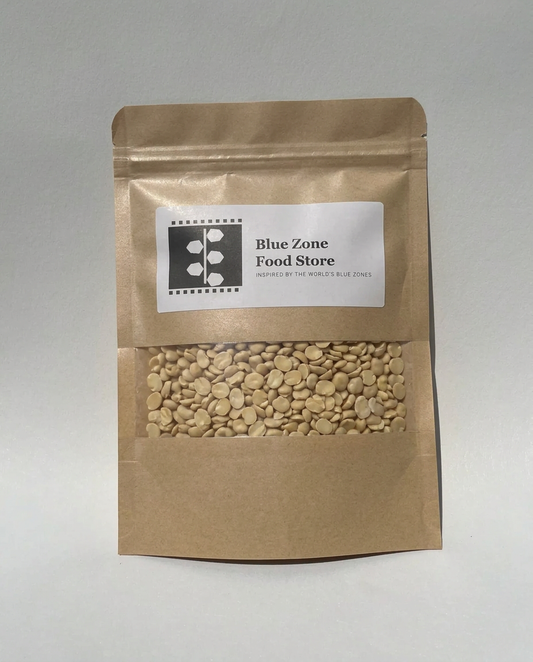 Dried Fava Beans in a kraft stand-up pouch with a clear window, Blue Zone Food Store label, on a light grey studio background